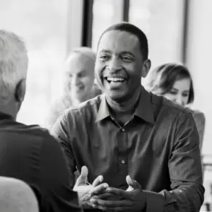 a man laughing at a group of people