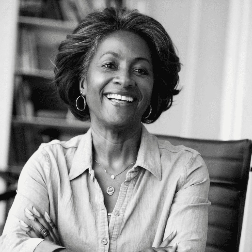 a woman smiling with her arms crossed